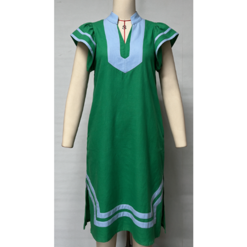 A green short-sleeve tunic dress with light blue trim and a light blue V-neck panel, displayed on a beige mannequin against a light gray background.