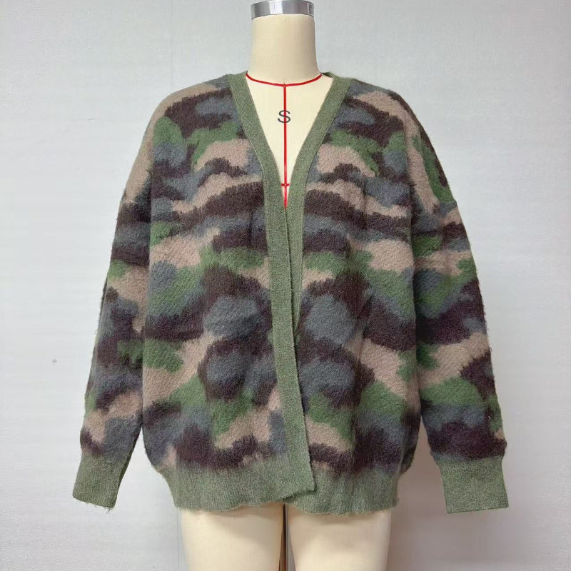 A fuzzy knit cardigan sweater with a camouflage pattern in shades of green, brown, and beige, displayed on a cream-colored mannequin torso against a plain light gray background.