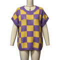 A purple and yellow checkerboard knit sweater displayed on a beige mannequin torso against a plain light gray wall.