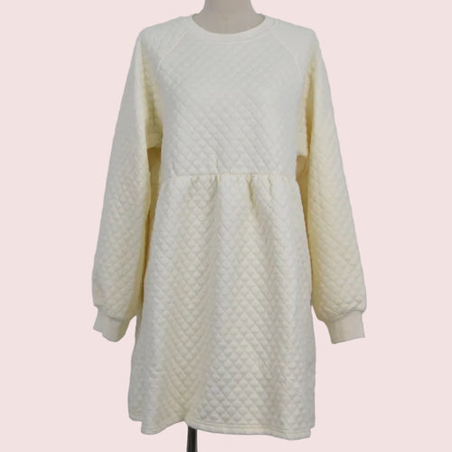 An off-white quilted long-sleeve dress displayed on a mannequin against a plain light gray background.