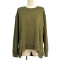 An olive green long-sleeve top with a high-low hem and raw, distressed edges, displayed on a mannequin torso against a white background.