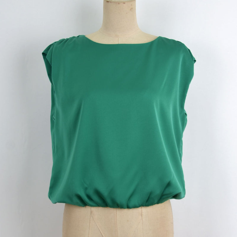 A green sleeveless top displayed on a beige dress form mannequin against a plain white background.