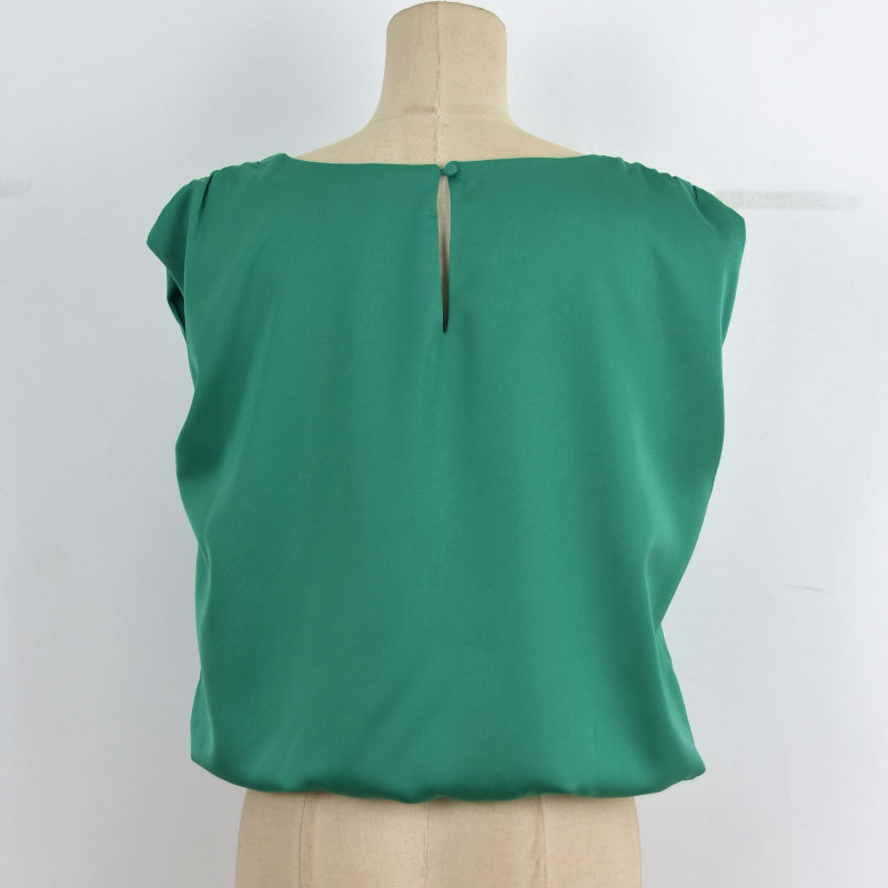 A green short-sleeve blouse displayed on a beige dress form mannequin against a plain white background.