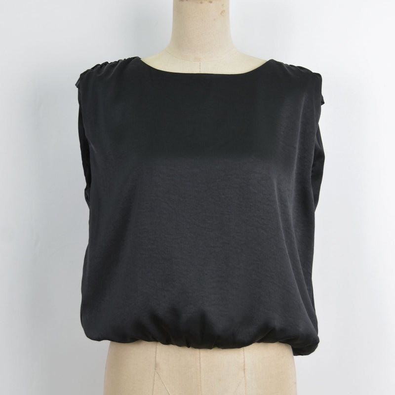 A black sleeveless top displayed on a beige dress form mannequin against a plain white background.