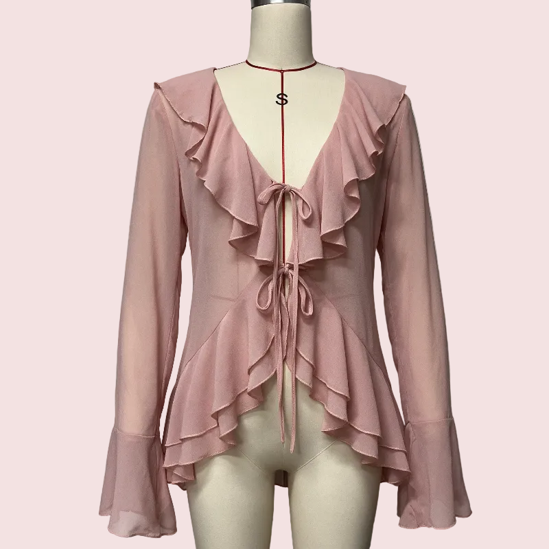 A pink long-sleeve blouse with layered ruffles, a deep V-neckline, and front tie details, displayed on a cream mannequin against a plain light gray background.