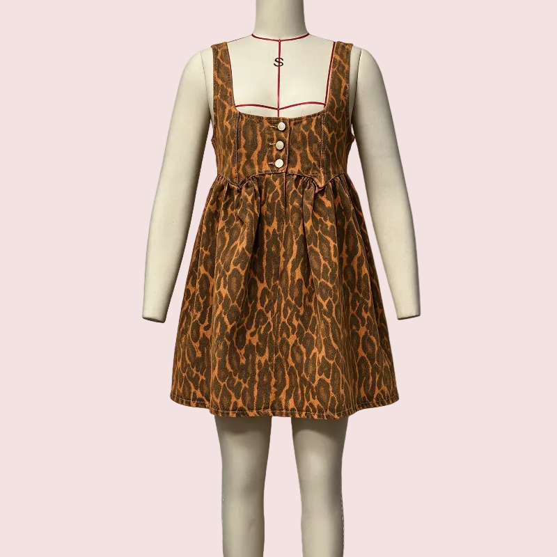 A sleeveless brown and orange leopard-print dress displayed on a cream mannequin against a light gray wall, with a wooden floor visible at the bottom.