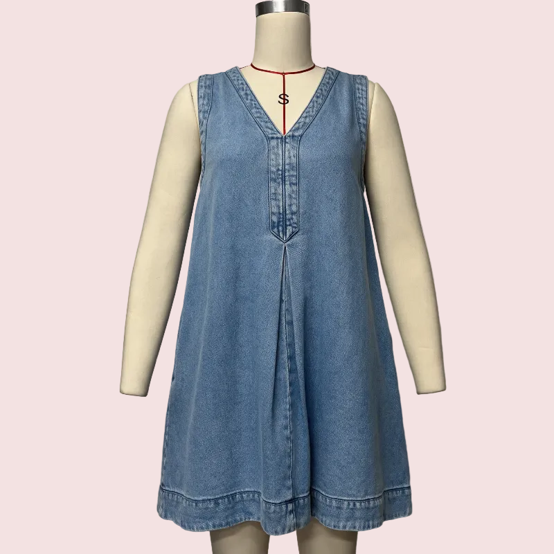 A sleeveless light blue denim dress displayed on a cream-colored mannequin torso against a plain light gray background. The dress has a V-neckline with button details down the front and a relaxed, flared silhouette.