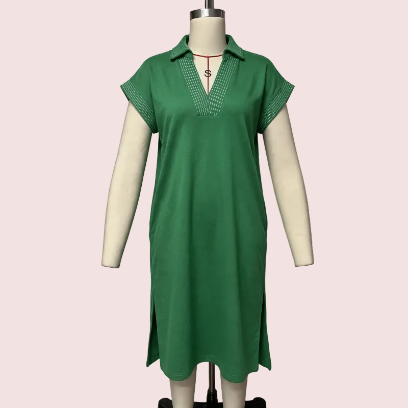 A green short-sleeve polo dress displayed on a cream-colored mannequin against a light gray background.
