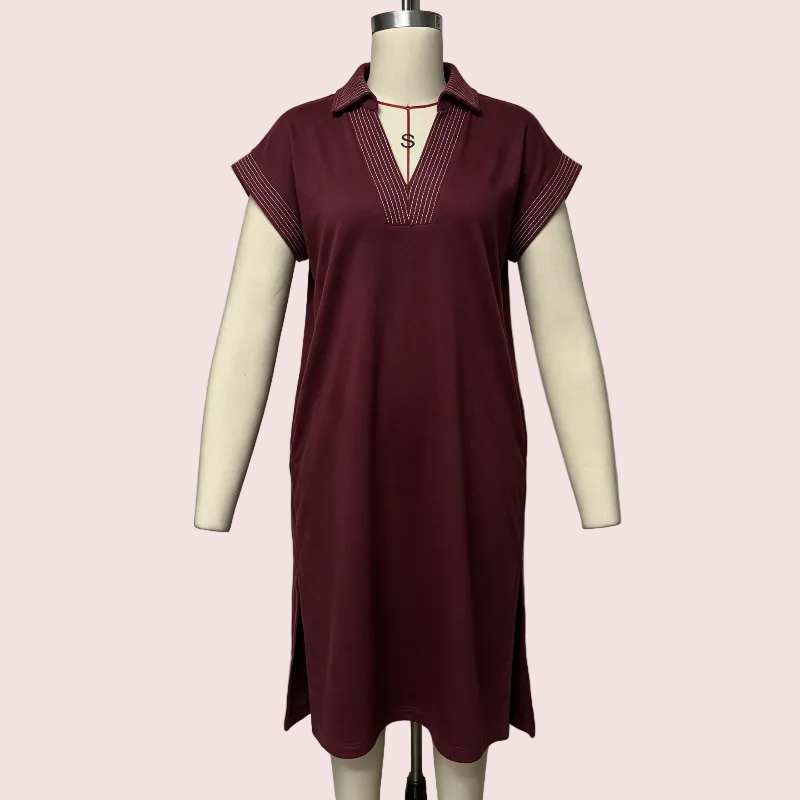 A short-sleeve collared tunic dress in deep burgundy displayed on a cream mannequin against a pale pink background.