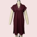 A short-sleeve collared tunic dress in deep burgundy displayed on a cream mannequin against a pale pink background.