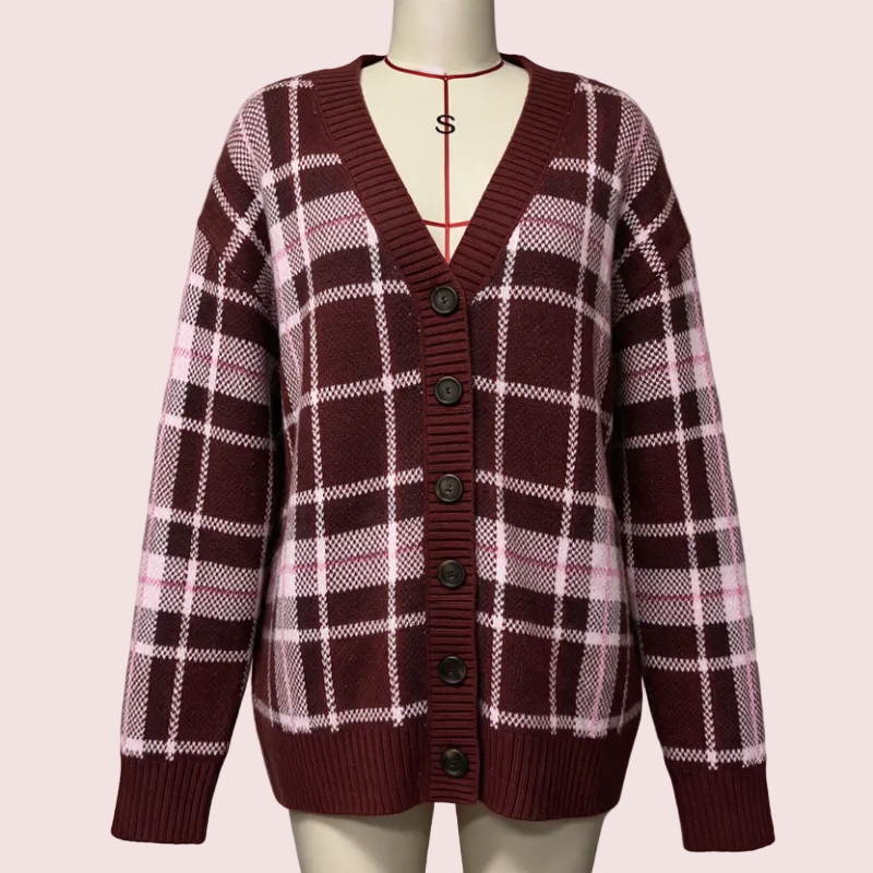A women's knit cardigan sweater displayed on a cream mannequin torso. The cardigan features a maroon and pink plaid pattern with white grid lines, a V-neck, and dark brown buttons.