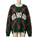 A green Christmas-themed knit sweater with a red and green plaid pattern and 'HO HO HO' in white letters across the chest, displayed on a mannequin.