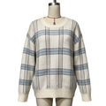 A cream-colored knit sweater with a blue and brown plaid pattern, displayed on a beige mannequin torso against a light gray background.
