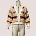 A multicolor striped crochet cardigan sweater displayed on a cream dress form mannequin. The cardigan features horizontal stripes of yellow, pink, red, black, and white, with a solid white ribbed V-neck, button closure, and cuffs.
