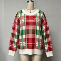 A festive Christmas plaid knit sweater displayed on a mannequin. The sweater features a holiday tartan pattern in red, green, and white, with ribbed cuffs, collar, and hem.