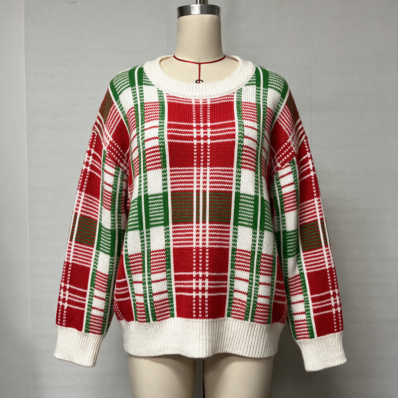 A festive Christmas plaid knit sweater displayed on a mannequin. The sweater features a holiday tartan pattern in red, green, and white, with ribbed cuffs, collar, and hem.