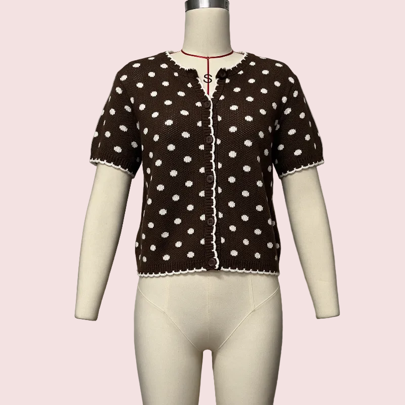 A brown short-sleeve knit top with white polka dots and a scalloped edge, displayed on a cream-colored mannequin torso against a light gray background.