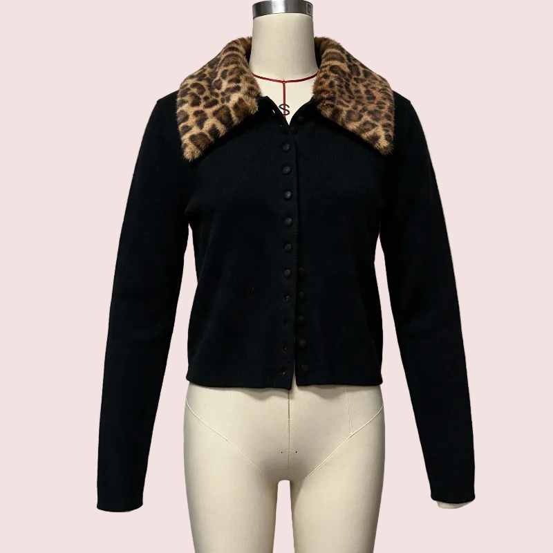 A black cropped cardigan sweater with a leopard-print faux fur collar, displayed on a cream mannequin torso against a light gray background.