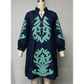 A navy blue long-sleeve tunic dress with mint green baroque-style embroidery, displayed on a mannequin against a light gray background.