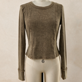 A long-sleeve cropped top in a washed taupe-brown color, displayed on a cream mannequin against a neutral beige background.