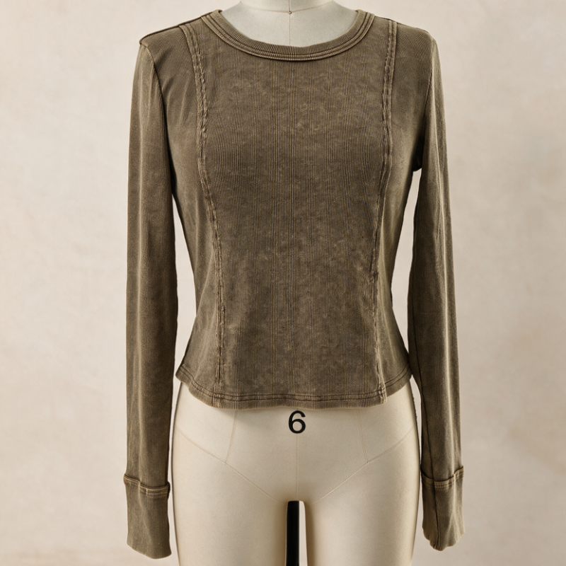 A long-sleeve cropped top in a washed taupe-brown color, displayed on a cream mannequin against a neutral beige background.
