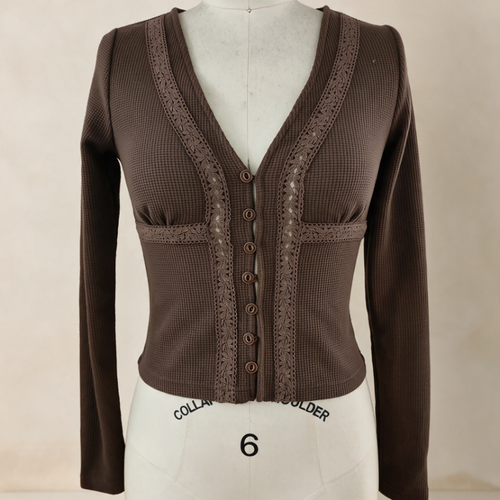 A brown ribbed knit cardigan sweater with lace trim and button details, displayed on a white mannequin torso against a light beige background.