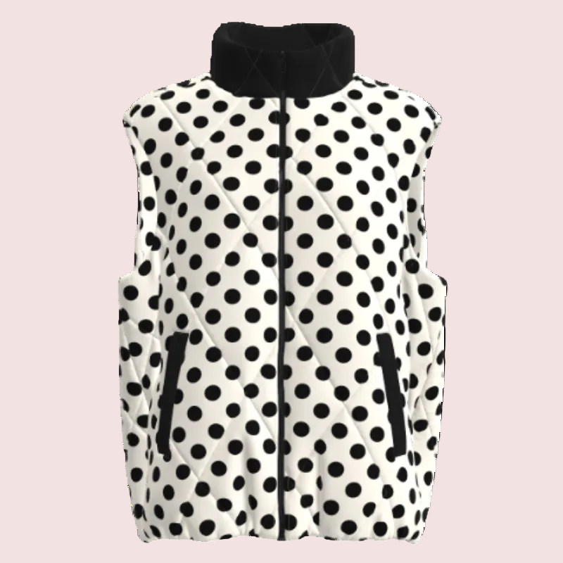 A sleeveless quilted vest with a black and white polka dot pattern, featuring a black stand-up collar, black front zipper, and zippered hand pockets, shown against a plain white background.