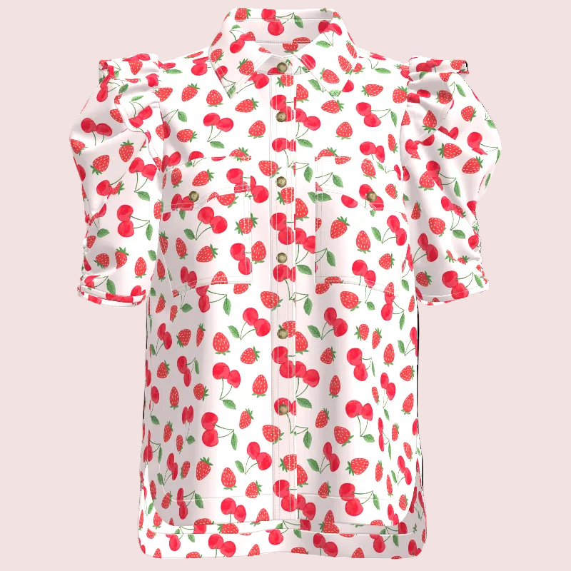 A white short-sleeve blouse with a red strawberry and cherry print, featuring ruffled shoulders and a pointed collar, shown on a plain white background.